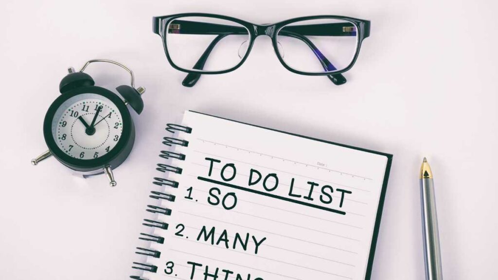 to do list with glasses and analog clock on table